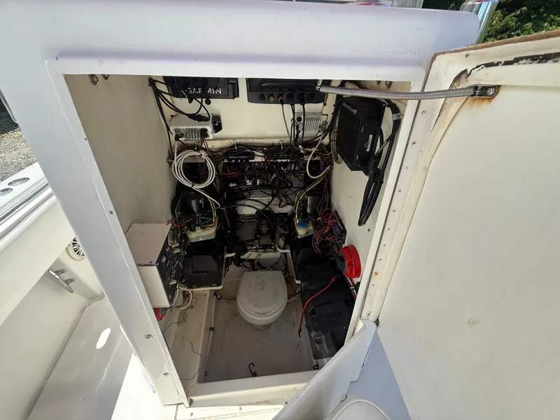 Slide: The Image of Electrical wiring and components inside a 2002 Contender 27 Tournament boat compartment. - 30