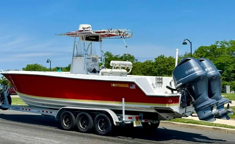 Slide: The Image of 2002 Contender 27 Tournament boat with dual Yamaha engines on a trailer. - 40
