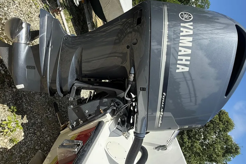 Slide: The Image of Yamaha outboard motor on a 2002 Contender 27 Tournament boat, parked on gravel. - 41