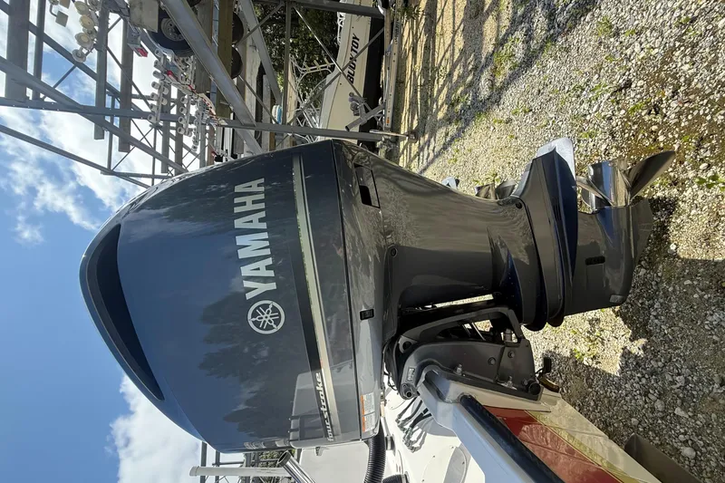 Slide: The Image of Yamaha outboard motor on 2002 Contender 27 Tournament boat, parked on gravel. - 42