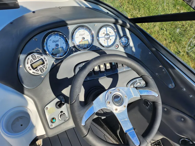 Slide: The Image of Dashboard of a 2007 Tigé 22i boat with steering wheel and gauges. - 12