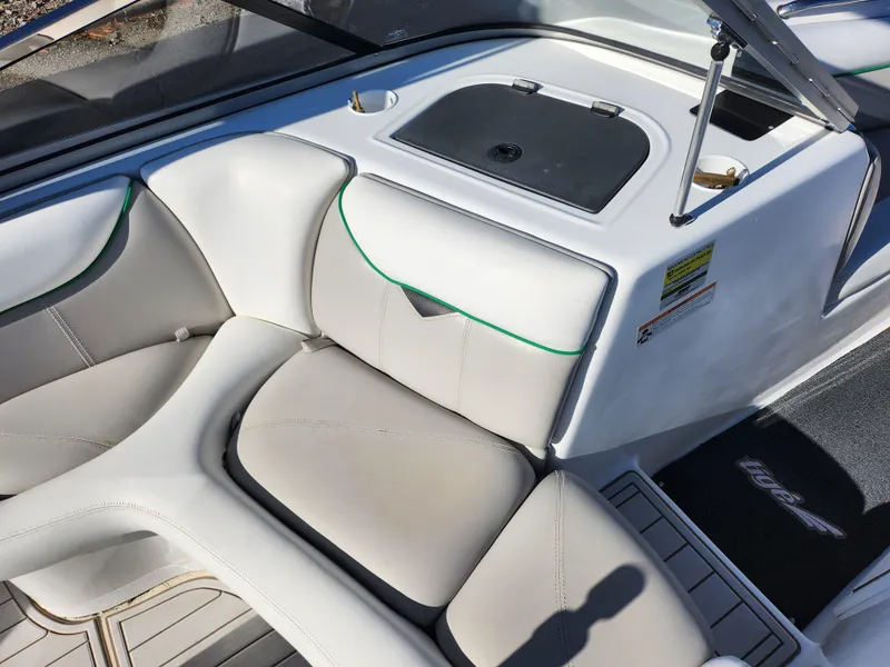 Slide: The Image of 2007 Tigé 22i boat interior with white seating and storage compartment. - 13