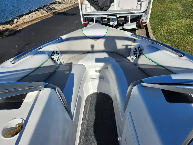 Slide: The Image of 2007 Tigé 22i boat interior with seating and speakers, parked near water. - 15