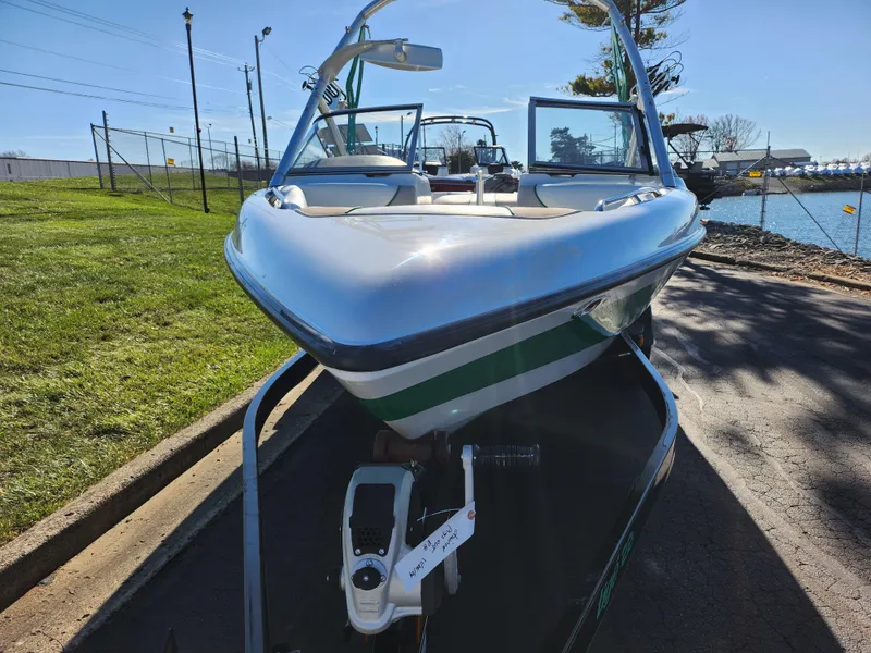 Slide: The Image of 2007 Tigé 22i boat on trailer near waterfront, sunny day. - 7
