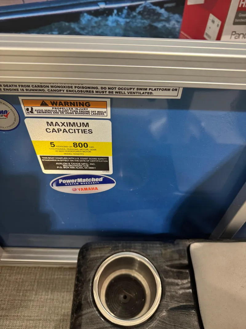 Slide: The Image of Warning label on Avalon 1575 23 Venture CR, 2024 model, showing maximum capacity and safety instructions. - 10