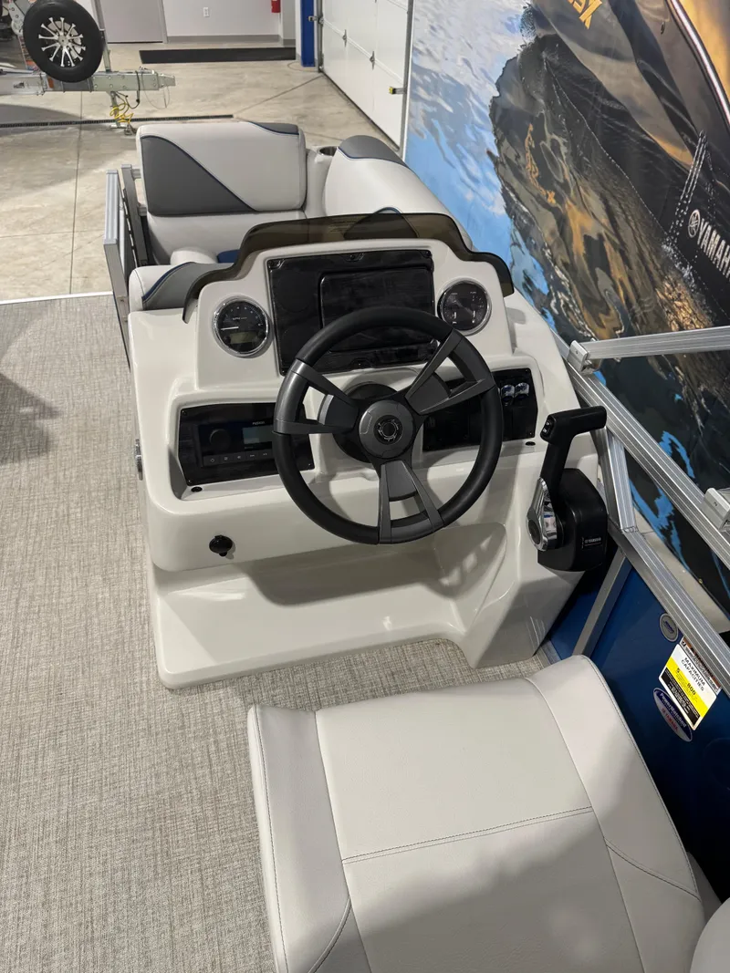 Slide: The Image of 2024 Avalon 1575 23 Venture CR boat helm with steering wheel and controls. - 5