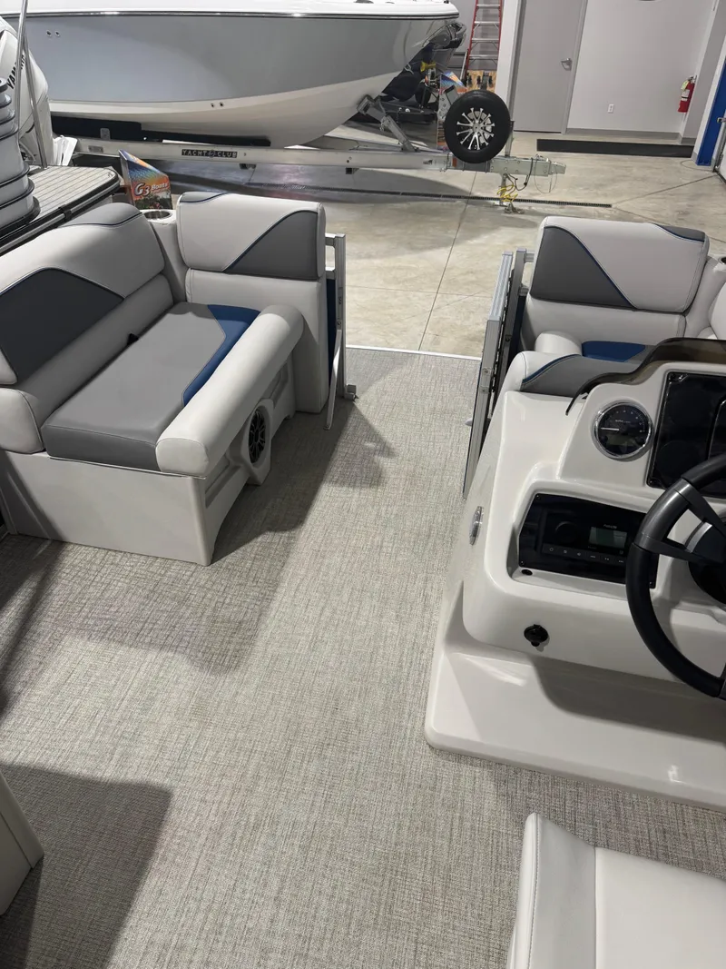 Slide: The Image of 2024 Avalon 1575 23 Venture CR boat interior with seating and steering console. - 6
