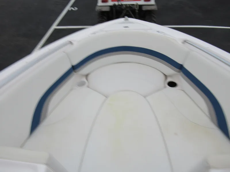 Slide: The Image of 2004 Yamaha Boats SX230 bow seating area with blue and white upholstery. - 15