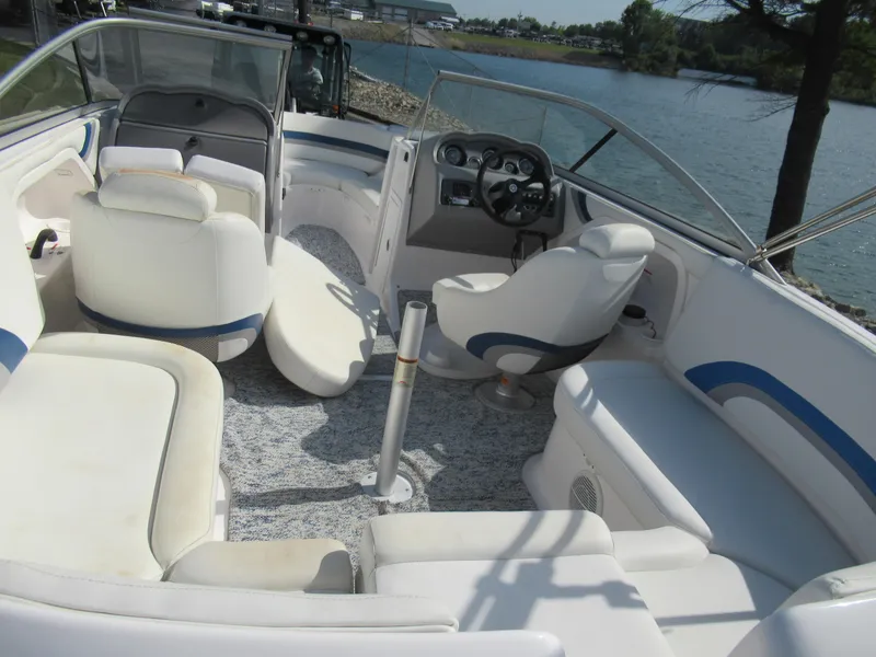 Slide: The Image of 2004 Yamaha Boats SX230 interior with white seating and steering console. - 22