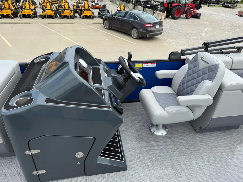 Slide: The Image of 2024 Massimo Marine P 24 LIMITED QUAD boat interior with steering console and cushioned seat. - 6