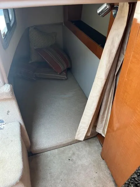 Slide: The Image of 2008 Chaparral Signature 250 cabin interior with cozy bedding and wooden accents. - 12