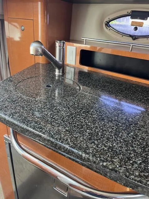 Slide: The Image of 2008 Chaparral Signature 250 boat interior with granite countertop and stainless steel sink. - 14
