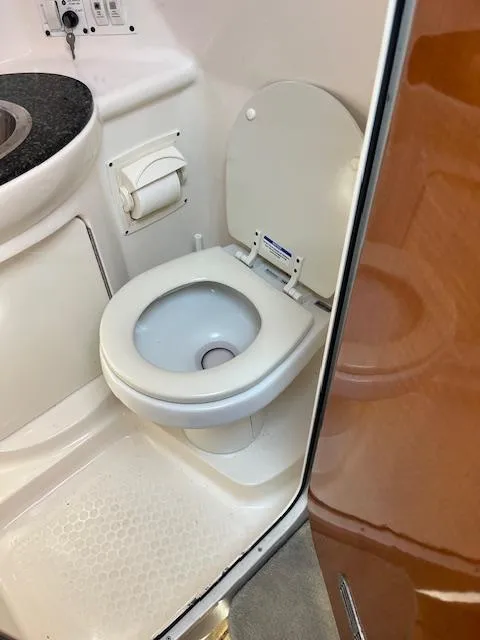 Slide: The Image of 2008 Chaparral Signature 250 boat bathroom with toilet and sink. - 17