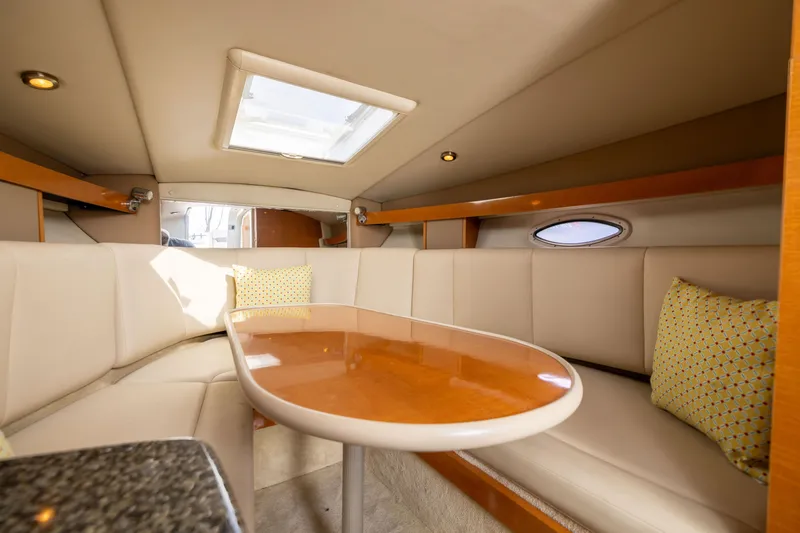 Slide: The Image of Interior of 2008 Chaparral Signature 250 boat with elegant seating and wooden table. - 22