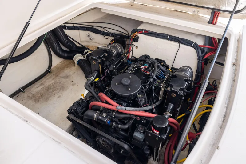 Slide: The Image of Engine compartment of a 2008 Chaparral Signature 250 boat, showcasing detailed wiring and components. - 24