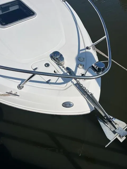 Slide: The Image of 2008 Chaparral Signature 250 boat bow with anchor and railing in water. - 5