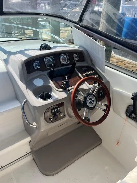 Slide: The Image of 2008 Chaparral Signature 250 boat helm with steering wheel and control panel. - 7