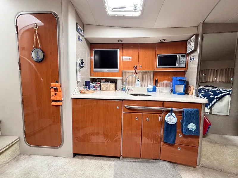Slide: The Image of Interior of a 2005 Formula 37 PC yacht with kitchenette and wooden cabinetry. - 12