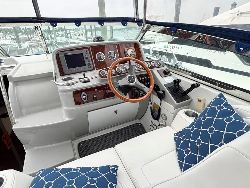 Slide: The Image of Cockpit of 2005 Formula 37 PC yacht with steering wheel, gauges, and blue cushions. - 7