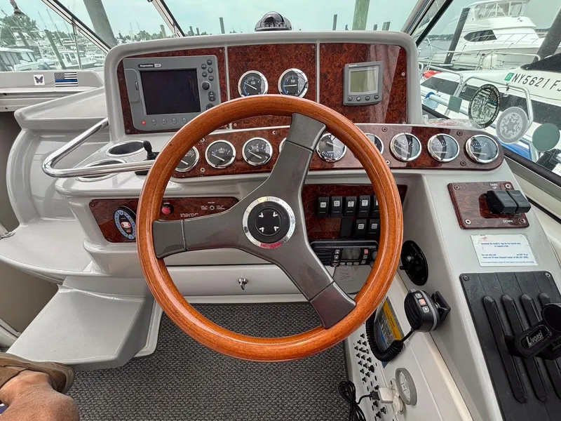 Slide: The Image of 2005 Formula 37 PC boat dashboard with wooden steering wheel and navigation instruments. - 8