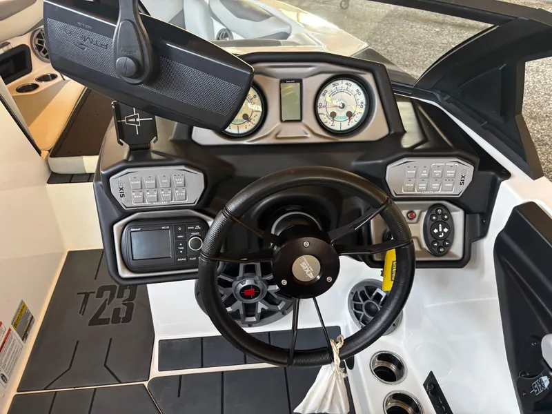 Slide: The Image of 2020 Axis T23 boat dashboard with steering wheel, gauges, and control panel. - 5