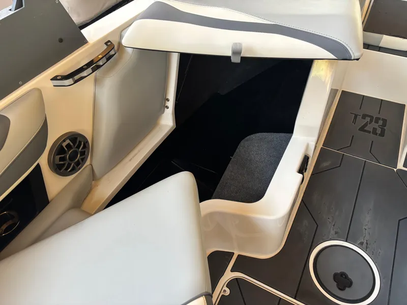 Slide: The Image of 2020 Axis T23 boat interior with open storage compartment and speaker. - 6