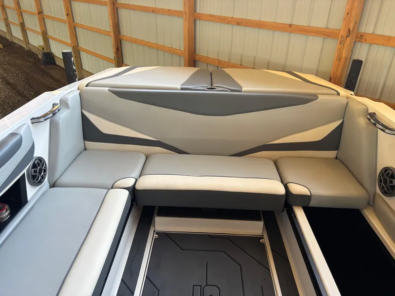 Slide: The Image of 2020 Axis T23 boat interior with gray and white seating, under a wooden shelter. - 8