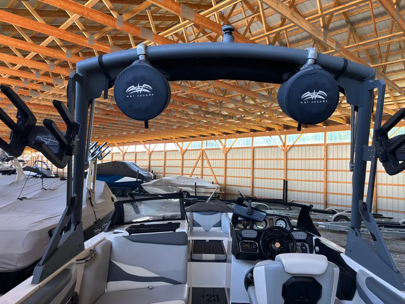 Slide: The Image of 2020 Axis T23 boat interior with Wet Sounds speakers in a wooden storage facility. - 9