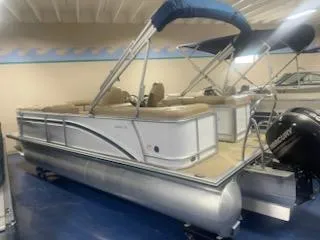 Slide: The Image of 2018 Harris Cruiser 220 pontoon boat with canopy in showroom. - 2