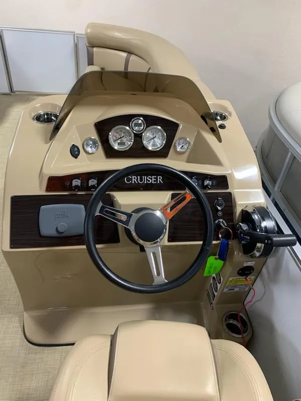 Slide: The Image of 2018 Harris Cruiser 220 boat dashboard with steering wheel and control panel. - 8