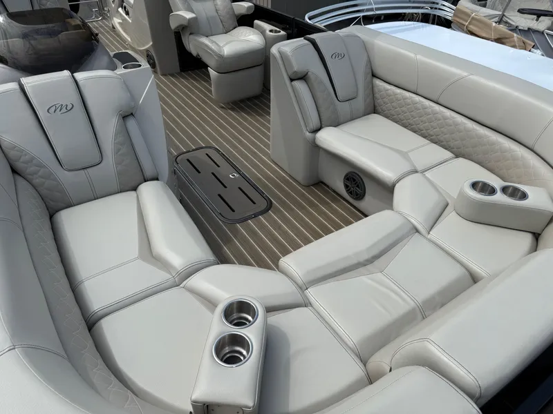 Slide: The Image of Luxurious seating on 2017 Manitou 24 Legacy Triple Tube boat with cup holders and elegant design. - 11