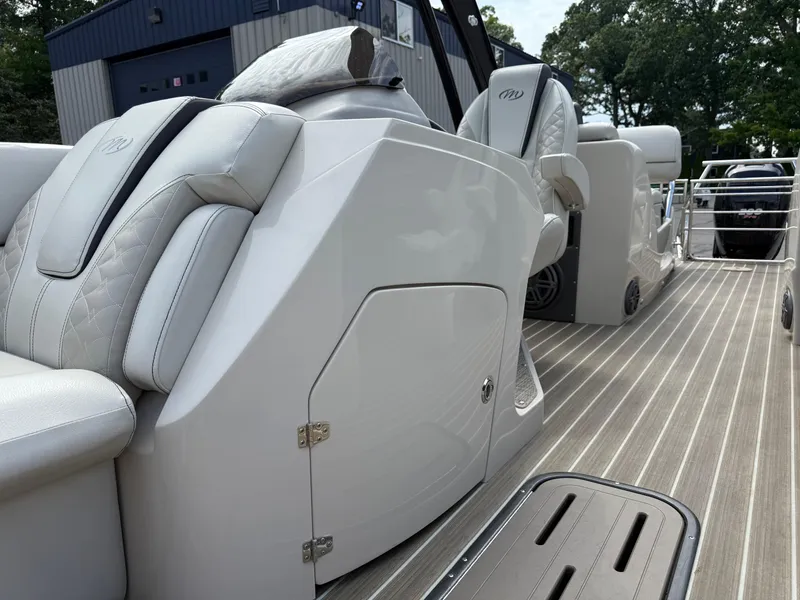 Slide: The Image of 2017 Manitou 24 Legacy Triple Tube boat interior with luxurious seating and sleek design. - 12