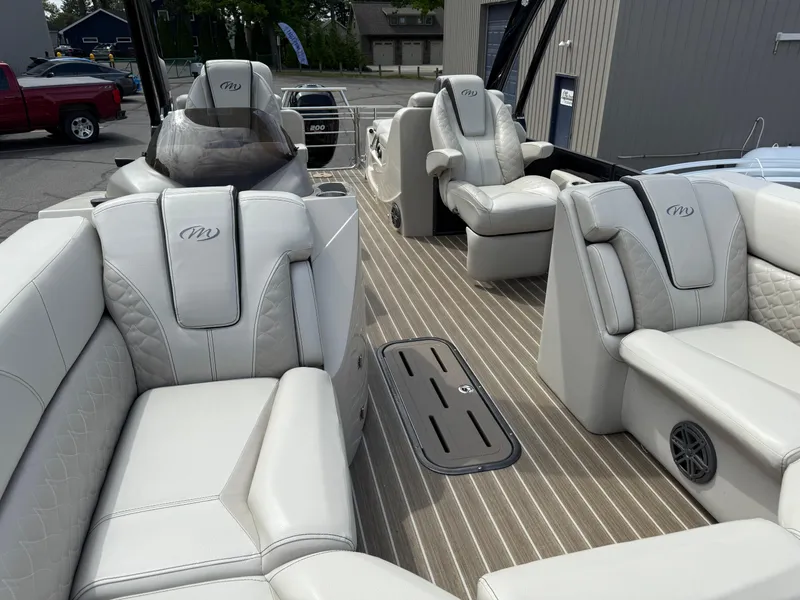 Slide: The Image of Luxurious interior of 2017 Manitou 24 Legacy Triple Tube pontoon boat with plush seating. - 16