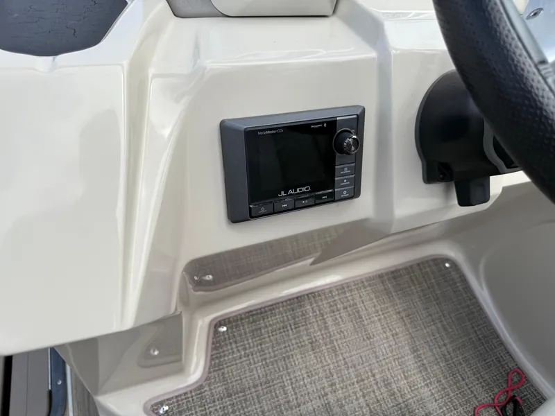 Slide: The Image of 2017 Manitou 24 Legacy Triple Tube dashboard with JL Audio system. - 23