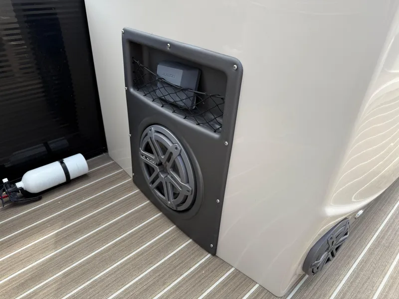 Slide: The Image of 2017 Manitou 24 Legacy Triple Tube boat with JL Audio speaker system on deck. - 24