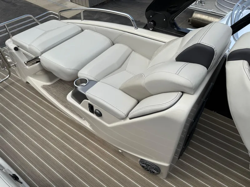 Slide: The Image of Luxurious seating on 2017 Manitou 24 Legacy Triple Tube boat, featuring sleek design and cup holder. - 26