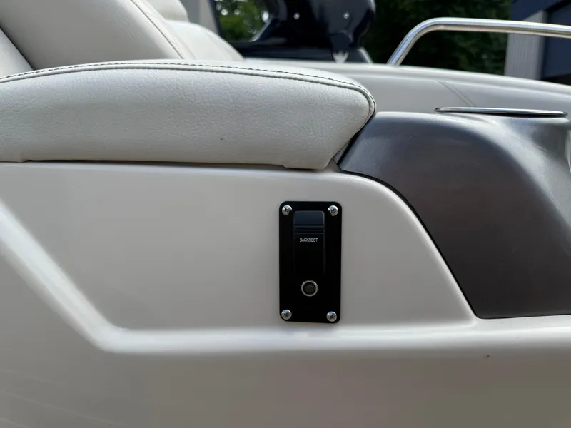 Slide: The Image of 2017 Manitou 24 Legacy Triple Tube boat interior with backrest control switch. - 27