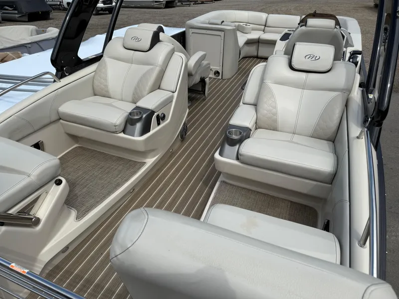 Slide: The Image of 2017 Manitou 24 Legacy Triple Tube boat interior with luxurious seating and modern design. - 32