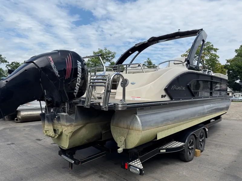 Slide: The Image of 2017 Manitou 24 Legacy Triple Tube pontoon boat with Mercury engine on trailer. - 6