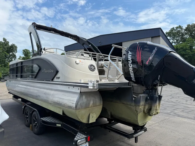 Slide: The Image of 2017 Manitou 24 Legacy Triple Tube pontoon boat with Mercury engine on trailer. - 7