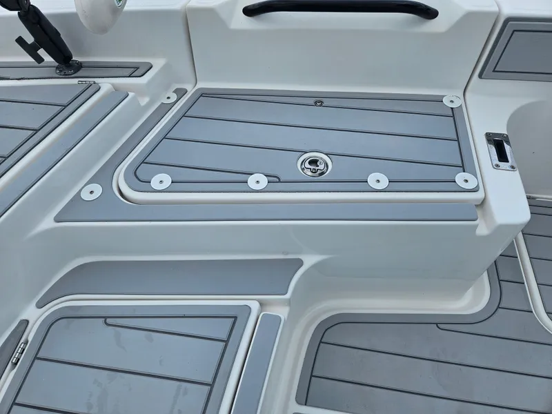 Slide: The Image of 2022 Sea Cat 260 Hybrid boat deck with gray non-slip surface and storage compartment. - 12