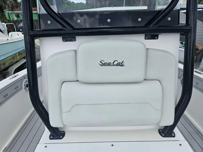 Slide: The Image of 2022 Sea Cat 260 Hybrid boat seat with logo, featuring sleek white upholstery. - 18