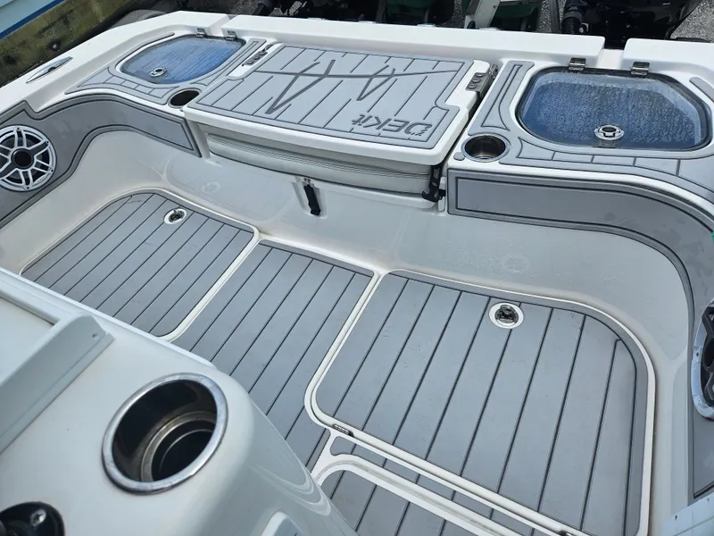 Slide: The Image of 2022 Sea Cat 260 Hybrid boat deck with gray non-slip flooring and storage compartments. - 20