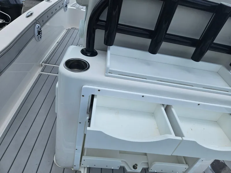 Slide: The Image of 2022 Sea Cat 260 Hybrid boat interior with storage compartments and cup holder. - 24
