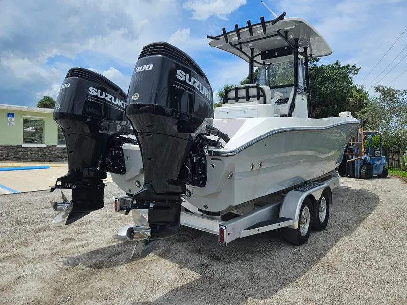 Slide: The Image of 2022 Sea Cat 260 Hybrid boat with dual Suzuki 300 engines on a trailer. - 3