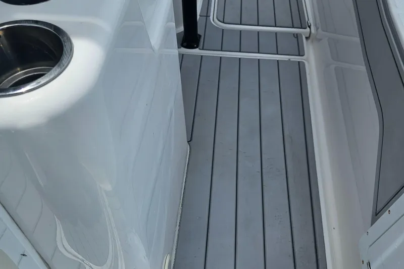 Slide: The Image of Interior view of 2022 Sea Cat 260 Hybrid boat, featuring sleek flooring and cup holders. - 31