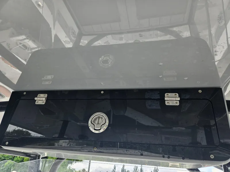 Slide: The Image of Storage compartment on a 2022 Sea Cat 260 Hybrid boat, featuring secure latches. - 35