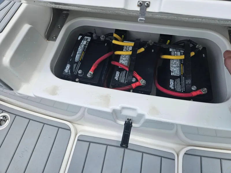 Slide: The Image of Batteries in a 2022 Sea Cat 260 Hybrid boat compartment, featuring red and yellow cables. - 45