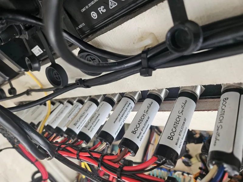 Slide: The Image of Electrical wiring and switches inside a 2022 Sea Cat 260 Hybrid boat. - 46