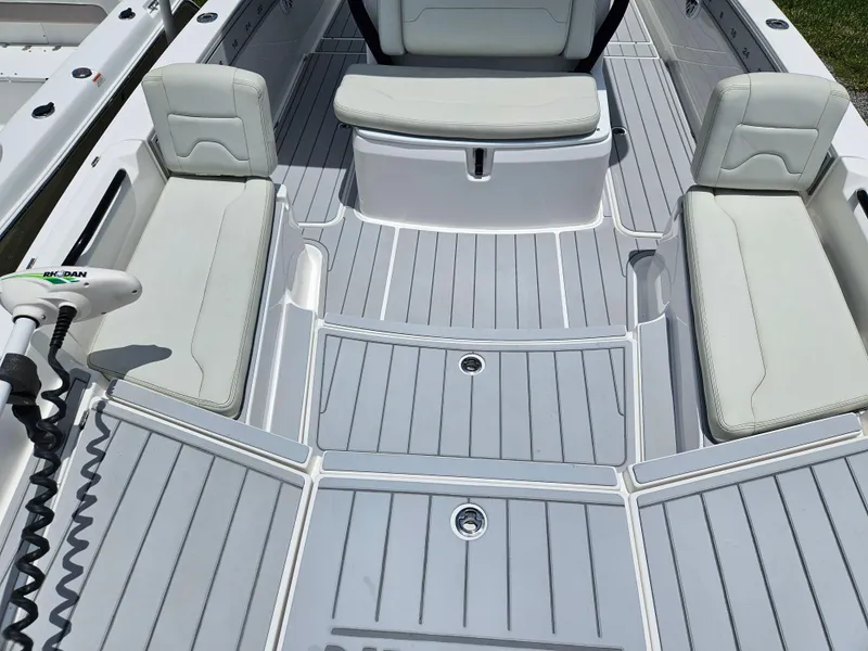 Slide: The Image of 2022 Sea Cat 260 Hybrid boat interior with cushioned seating and deck flooring. - 7